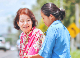 caregiver helping elder woman